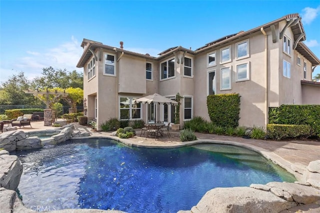 view of pool with a patio and an in ground hot tub