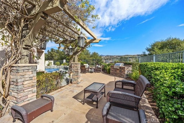 view of patio with a pergola and an outdoor kitchen