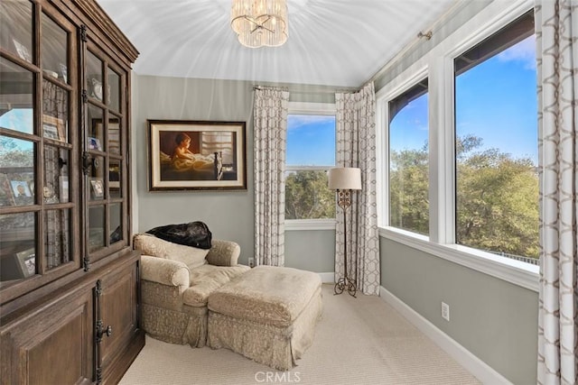 living area featuring carpet floors and a notable chandelier