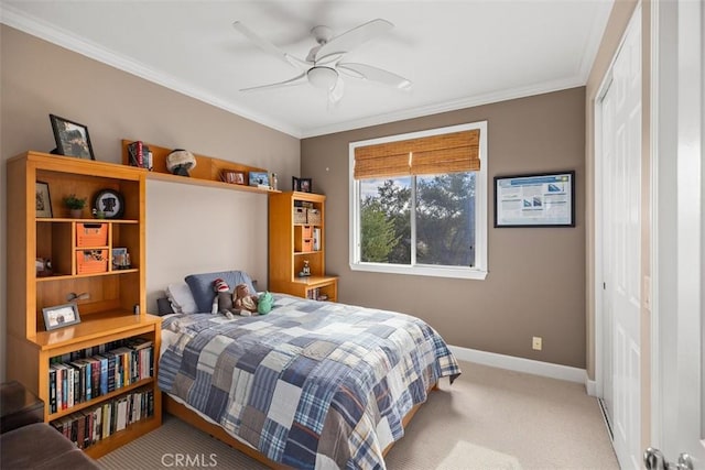 carpeted bedroom featuring ceiling fan, a closet, and ornamental molding