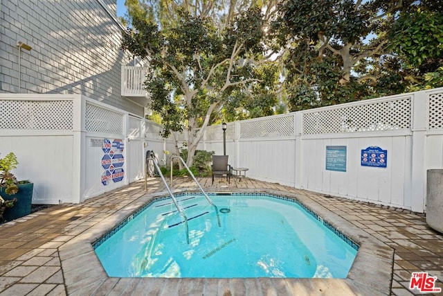 view of swimming pool featuring a patio