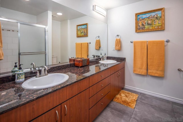 bathroom with a shower with shower door, toilet, and vanity