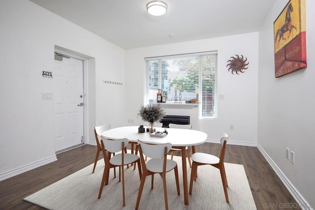 dining room with dark wood-type flooring