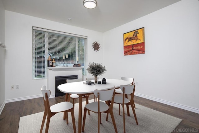 dining space featuring dark hardwood / wood-style flooring