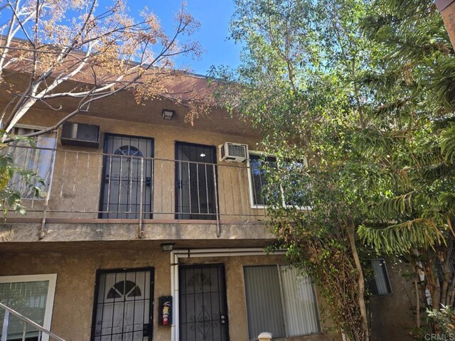 view of property with a wall mounted air conditioner