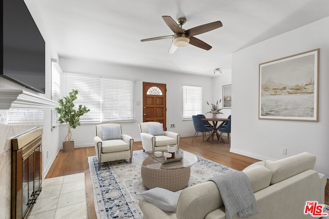 living room featuring ceiling fan and light hardwood / wood-style flooring