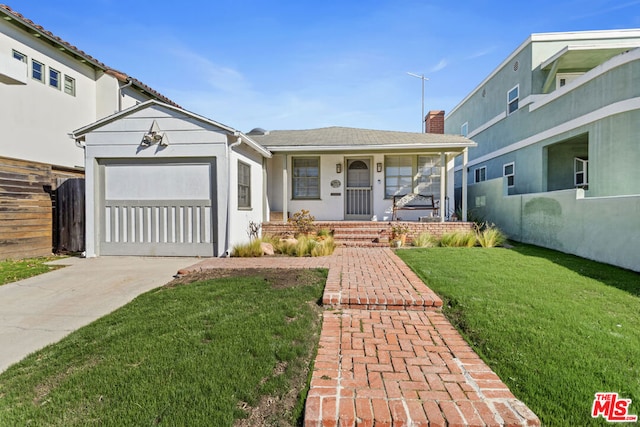 view of front of home featuring a garage, covered porch, and a front lawn