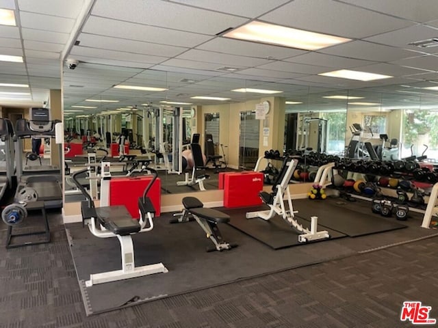 exercise room with a paneled ceiling