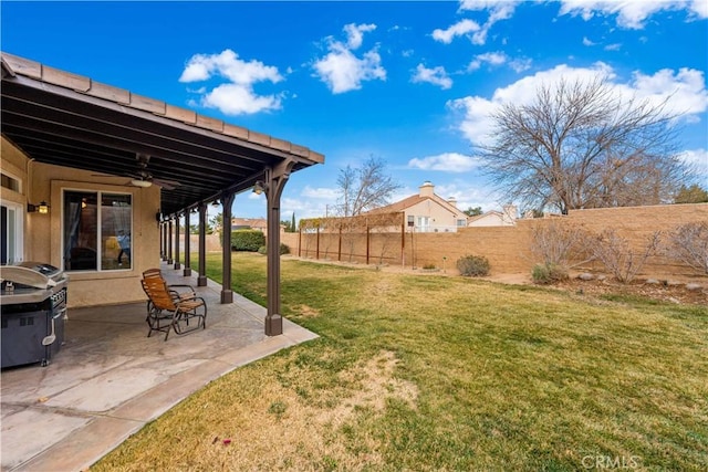 view of yard with ceiling fan and a patio area