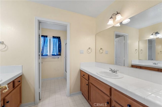 bathroom with a shower with shower door and vanity