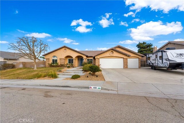 view of front of property with a front yard and a garage