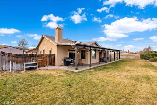 rear view of house with a patio area and a yard