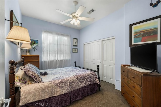 bedroom with ceiling fan, a closet, and dark colored carpet