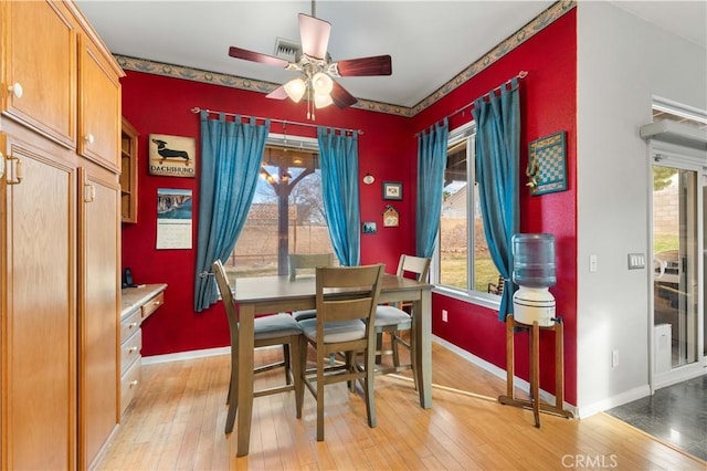 dining room featuring ceiling fan, a healthy amount of sunlight, and light hardwood / wood-style flooring