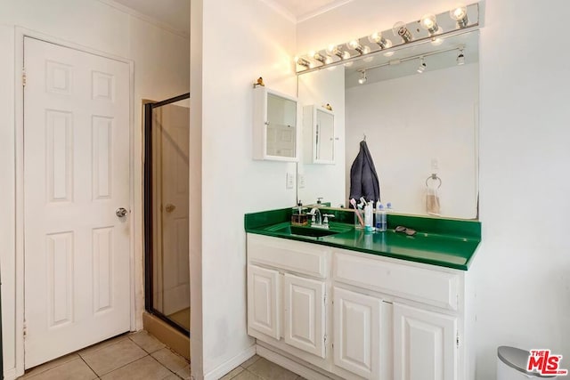 bathroom with tile patterned floors, vanity, and a shower with shower door