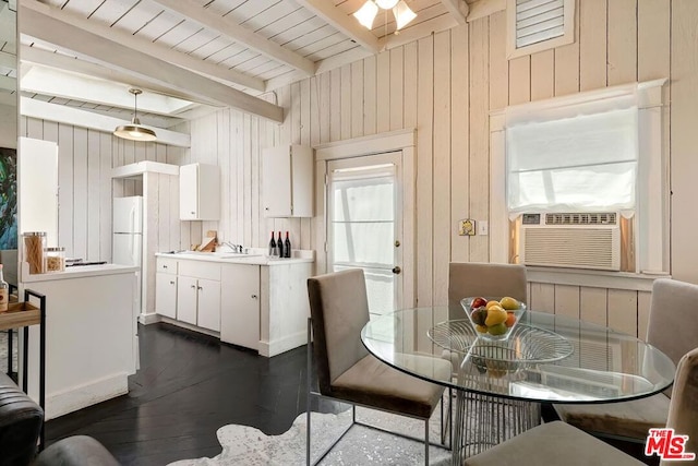 dining space with cooling unit, dark hardwood / wood-style flooring, beam ceiling, and wooden walls