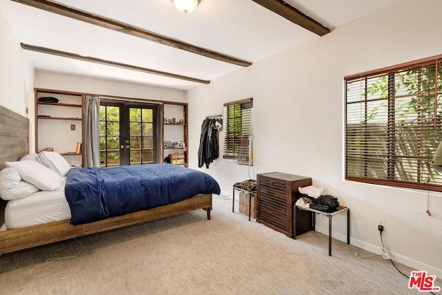 bedroom featuring light colored carpet, beam ceiling, and french doors