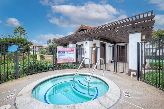 view of swimming pool featuring a pergola and a hot tub