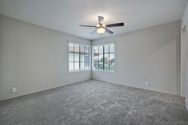 empty room featuring carpet and ceiling fan