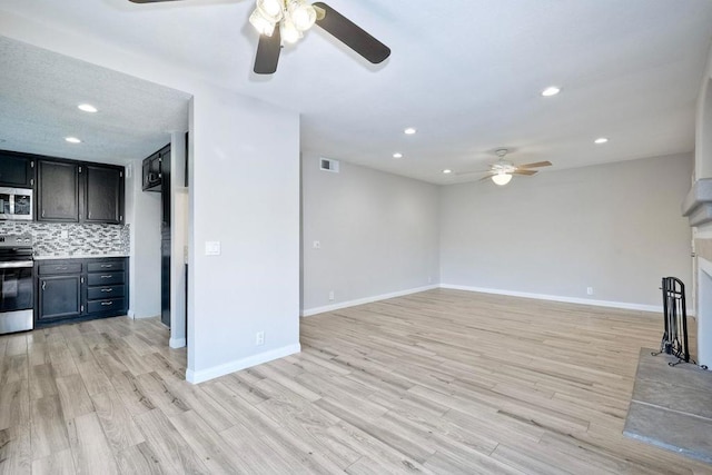 unfurnished living room with ceiling fan and light wood-type flooring