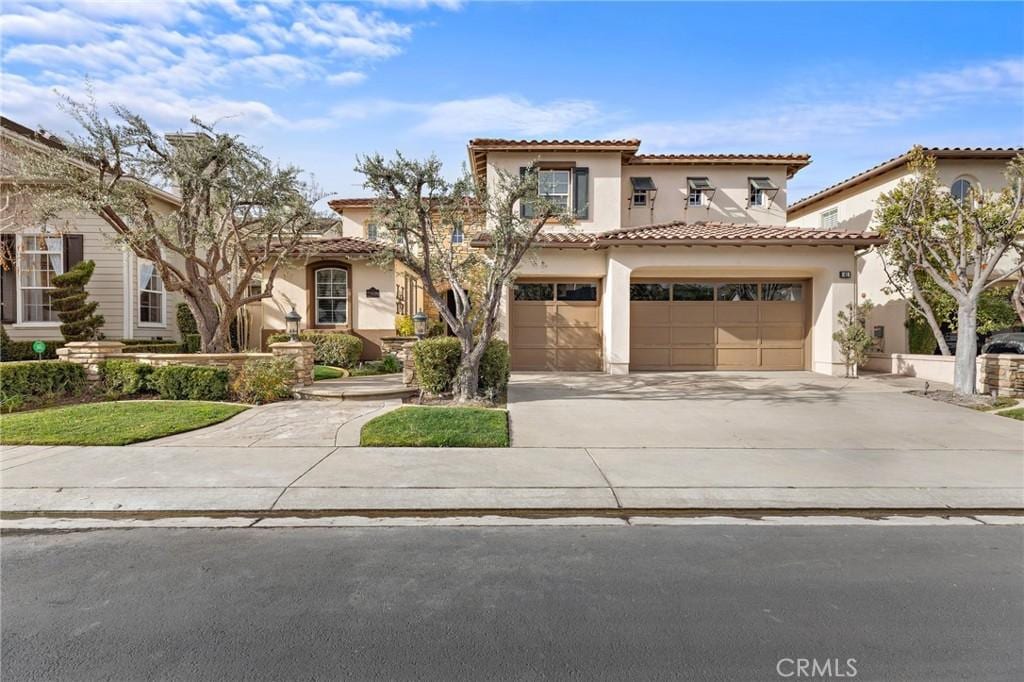 mediterranean / spanish-style home with a garage