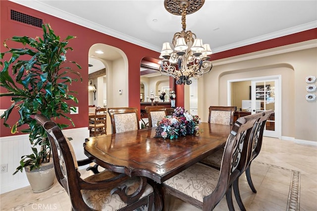 dining room featuring an inviting chandelier and crown molding