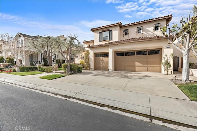 mediterranean / spanish home featuring a garage