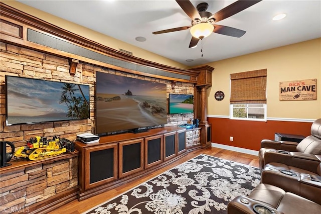 living room with ceiling fan and light hardwood / wood-style flooring