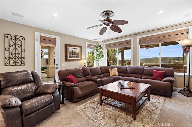 living room featuring ceiling fan and light colored carpet