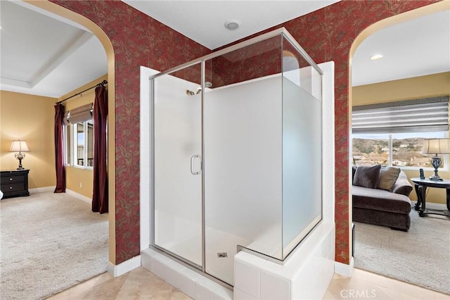 bathroom featuring an enclosed shower and plenty of natural light