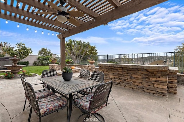 view of patio / terrace featuring ceiling fan and a pergola