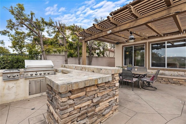 view of patio / terrace featuring a pergola, grilling area, and exterior kitchen