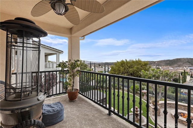 balcony with a mountain view and ceiling fan