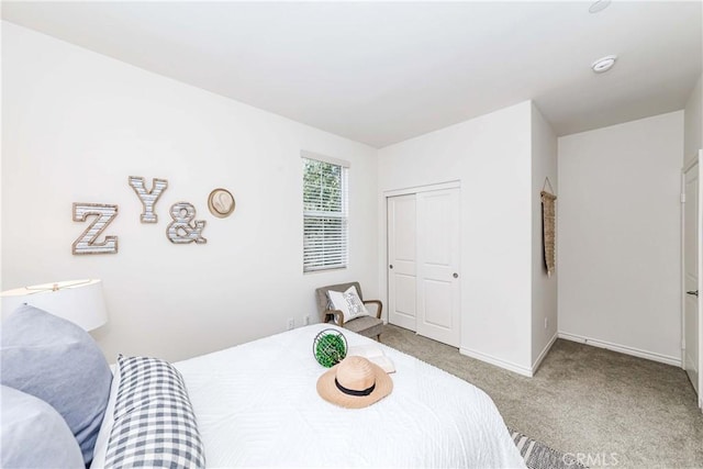 bedroom with light colored carpet and a closet