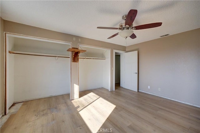 unfurnished bedroom featuring ceiling fan, a textured ceiling, and light hardwood / wood-style flooring