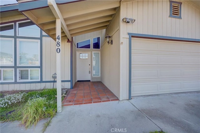 doorway to property with a garage