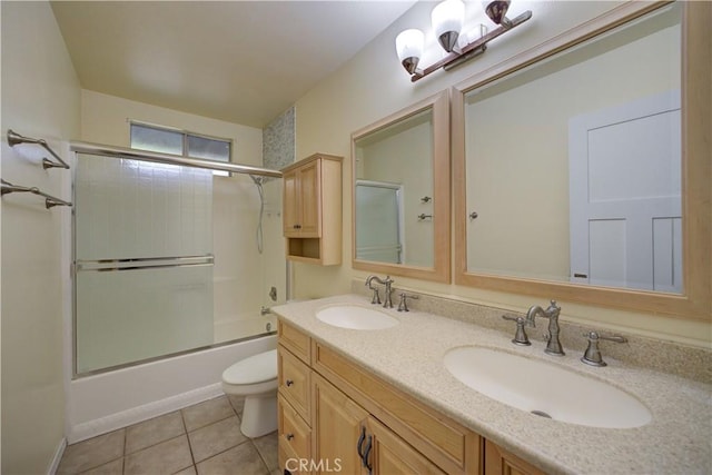 full bathroom with toilet, tile patterned flooring, enclosed tub / shower combo, and vanity