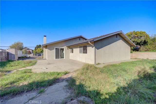 back of property featuring a patio