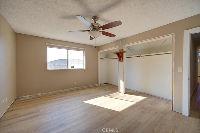 unfurnished bedroom with ceiling fan, a textured ceiling, and light hardwood / wood-style floors