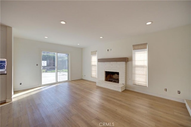 unfurnished living room featuring light hardwood / wood-style floors and a fireplace