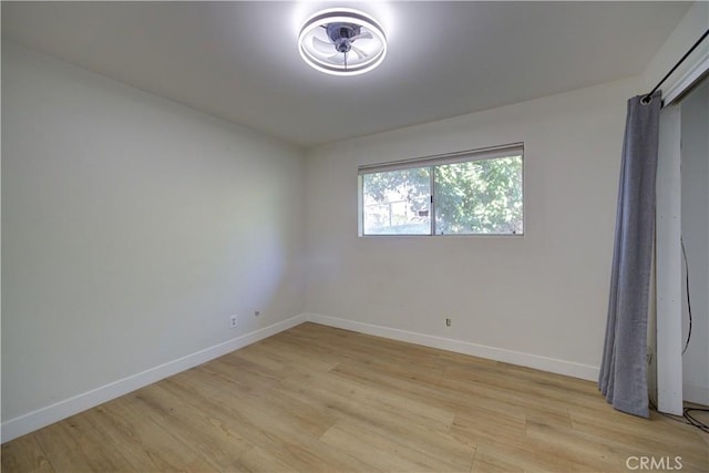 unfurnished room with light wood-type flooring