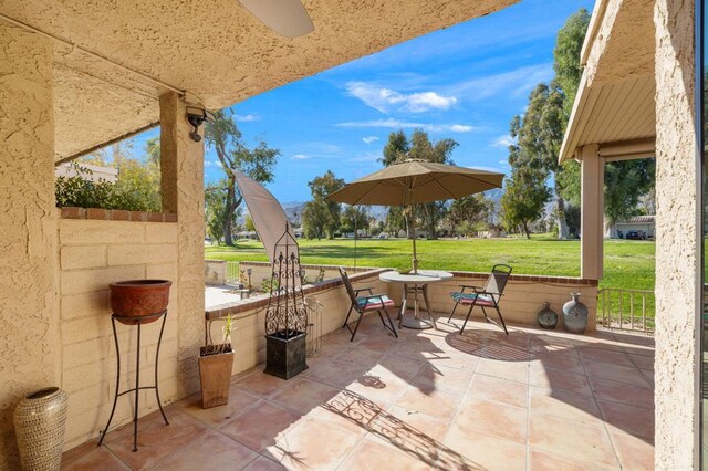 view of patio featuring ceiling fan