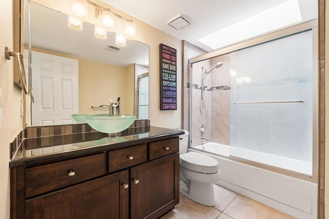 full bathroom featuring toilet, combined bath / shower with glass door, tile patterned flooring, and vanity