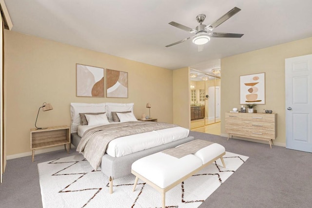 carpeted bedroom featuring ceiling fan and connected bathroom