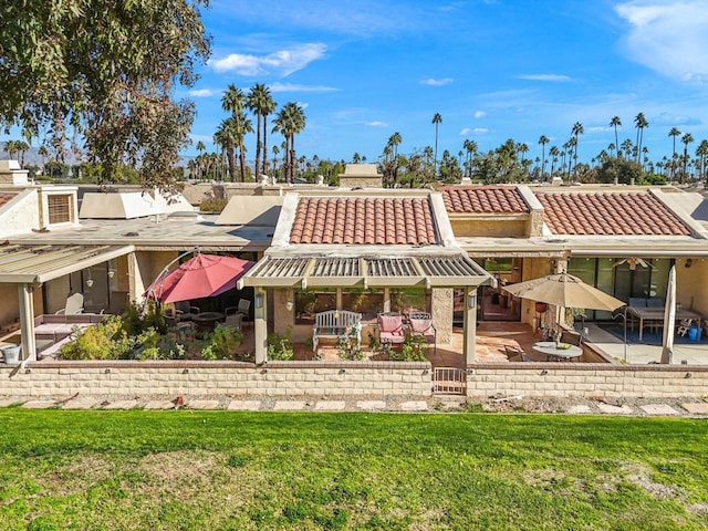 rear view of property featuring a patio area and a yard