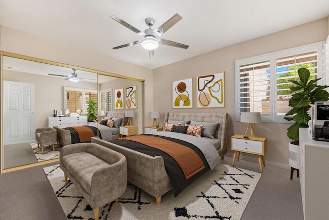 carpeted bedroom with ceiling fan and a closet