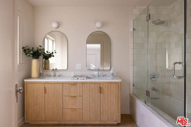 bathroom with enclosed tub / shower combo and vanity