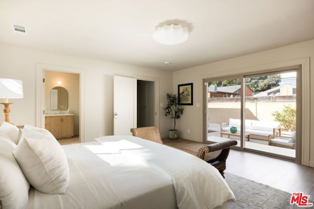 bedroom featuring ensuite bath, access to outside, and light hardwood / wood-style flooring