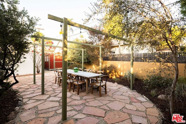 view of patio featuring a storage unit