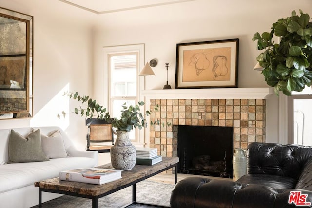 living room featuring a tile fireplace